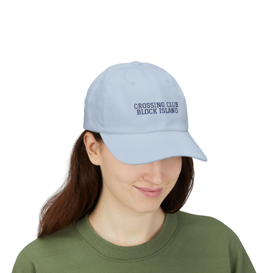 Woman in a green tee wearing the Light Blue Crossing Club Block Island hat, front view of embroidery