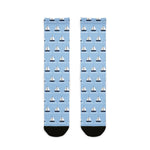 BlockBoundRI Sailboat Regatta socks flat lay, light blue nautical crew socks with rows of white sailboats