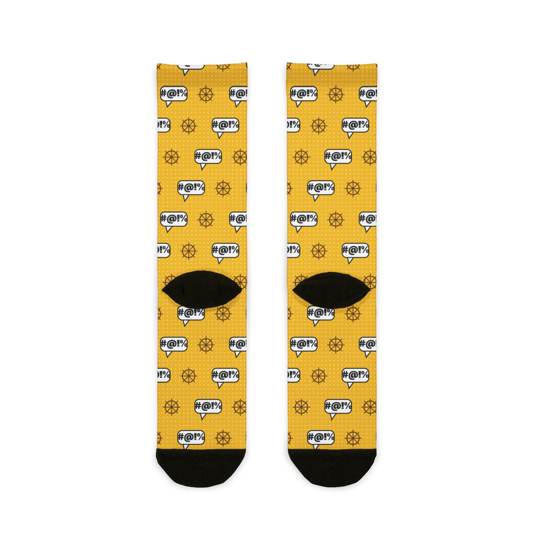 Back of the yellow Swear Like a Sailor nautical crew socks laid flat, showing ship wheel print and black heels