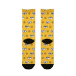 Back of the yellow Swear Like a Sailor nautical crew socks laid flat, showing ship wheel print and black heels