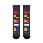 BLOCK ISLAND signal flag socks laid flat: navy crew socks with a column of colorful nautical flags and black toes