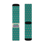 Upright pair of Quahog Squad funny beach socks laid flat, cream Quahog Squad label and black heel on teal clam print