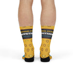 Rear view of yellow calamari ring crew socks on a standing model showing the Official State Appetizer band