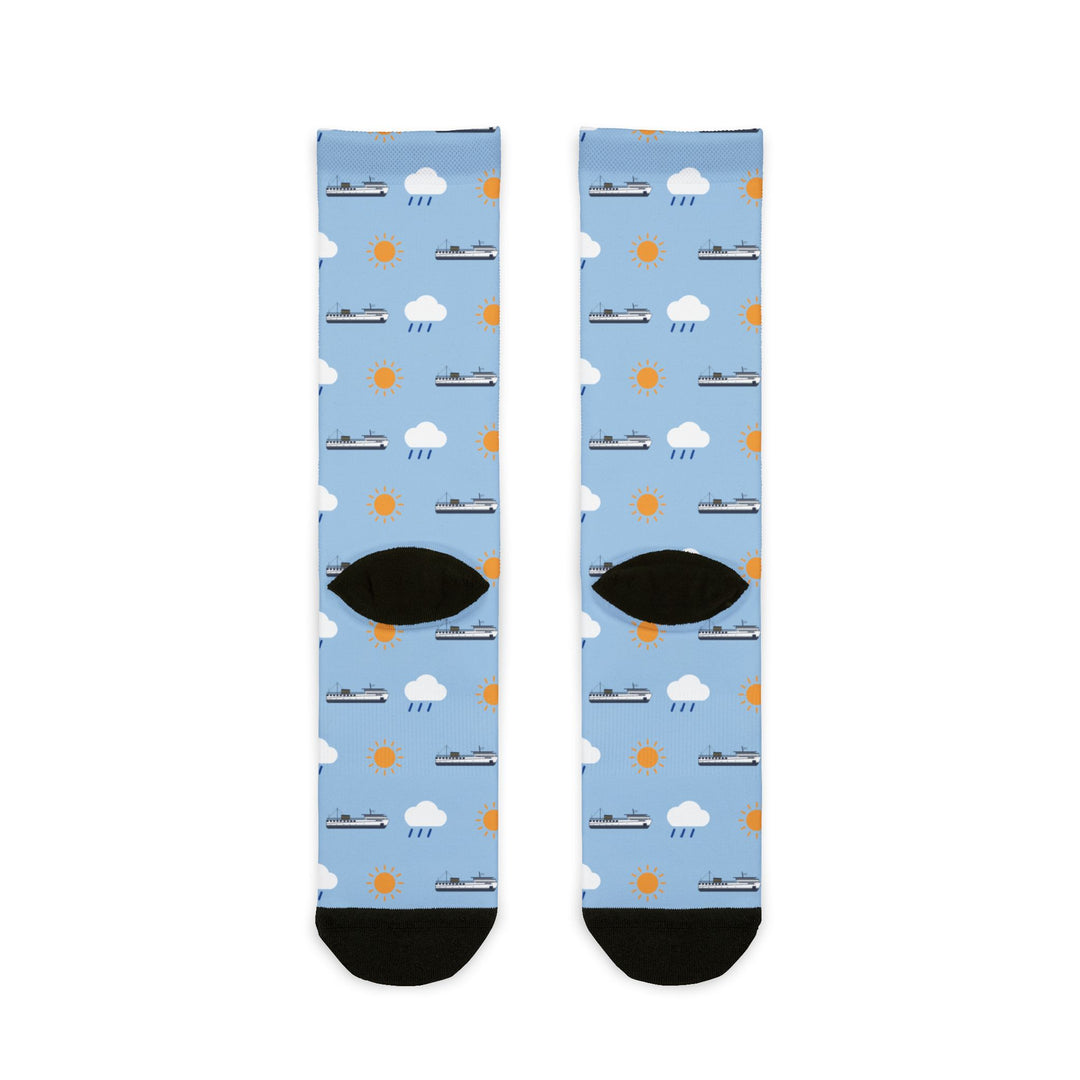 Back flat lay of light blue ferry crew socks with cloud and sun print, black heels and black toes