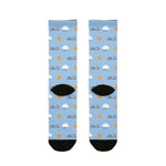Back flat lay of light blue ferry crew socks with cloud and sun print, black heels and black toes