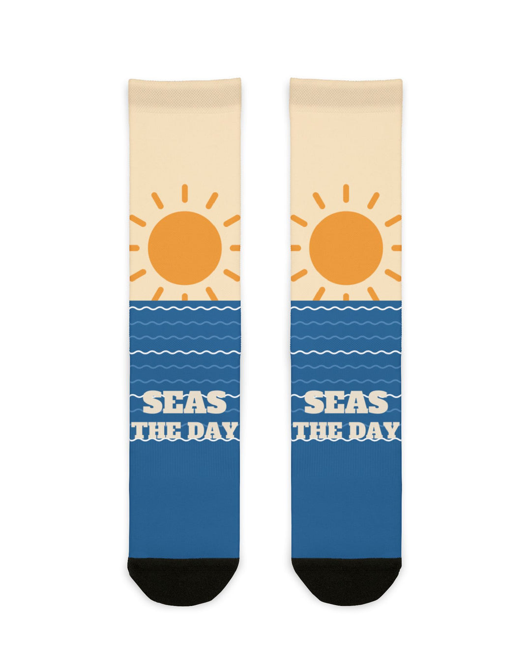 Seas the Day ocean socks laid flat: cream tops with an orange sun over blue wave-striped feet and black toes