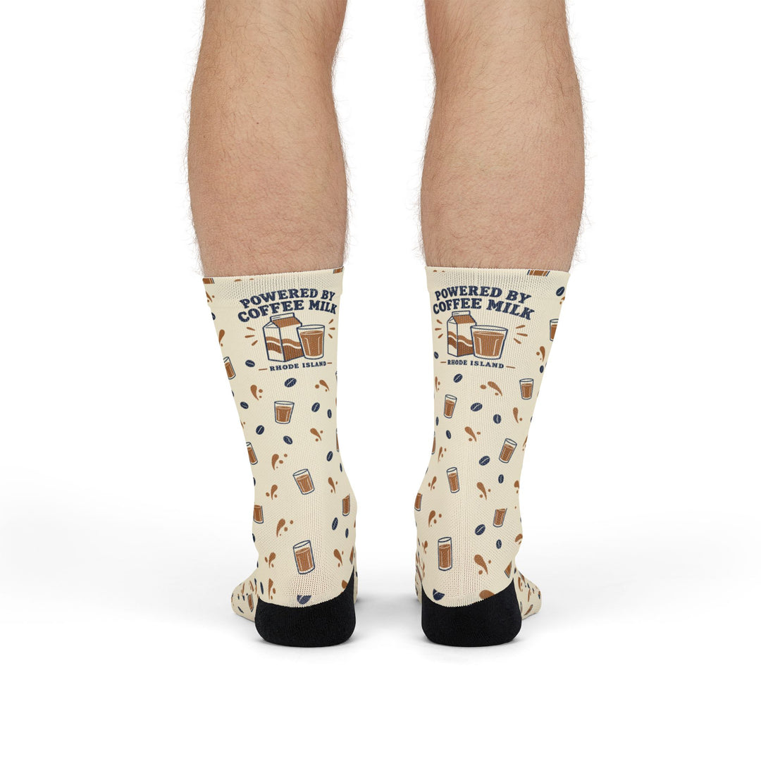 Front view of standing model in cream Powered by Coffee Milk Rhode Island socks with milk carton cuff graphic