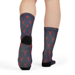 Rear view of feet in the navy lobster print Block Island socks showing the black heel and calf pattern