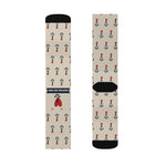 Flat lay of one pair of tan nautical crew socks showing the red heart anchor tattoo and navy anchor rows