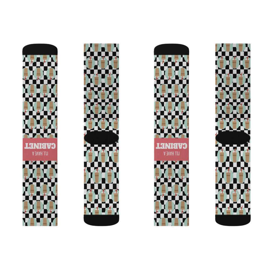 Flat lay of four I'll Have a Cabinet socks, fronts and backs, checkered funny beach socks with black toes and red bands