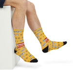 Close-up of feet in yellow nautical crew socks with ship wheels, #@!% speech bubbles and black toes