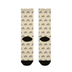 Back of My Legs Biked the Bluffs socks laid flat, cream with a repeating bicycle pattern and black heels