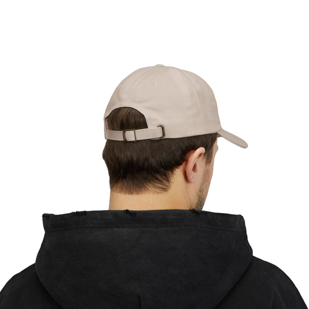 Back view of a man in a black hoodie wearing the Stone Block Island dad cap with buckle strap