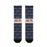 Are We There Yet? Block Island socks laid flat: navy crew socks with ferry print, cream slogan band, black toes