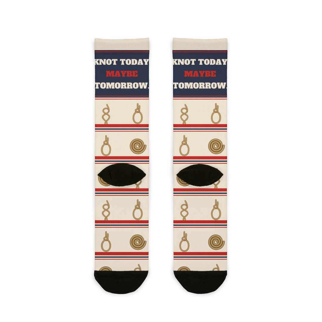 Back flat lay of Knot Today socks showing black heels, coiled rope and knot motifs with red and navy stripes