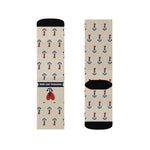 Flat lay of tan anchor tattoo socks with black cuffs and toes, front sock showing the Nautical But Nice label