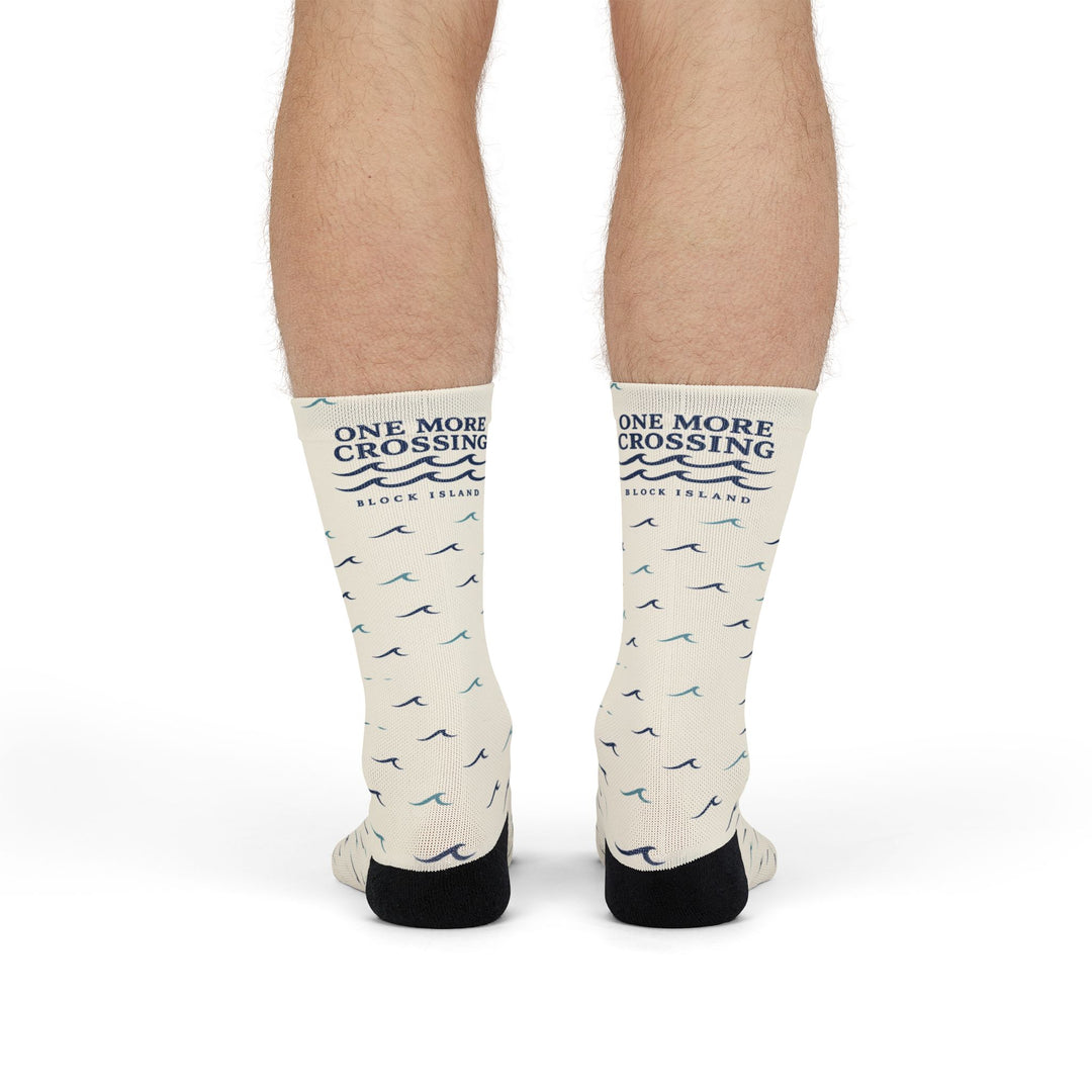 Standing legs in off-white Block Island socks showing the One More Crossing navy wave logo on the shins