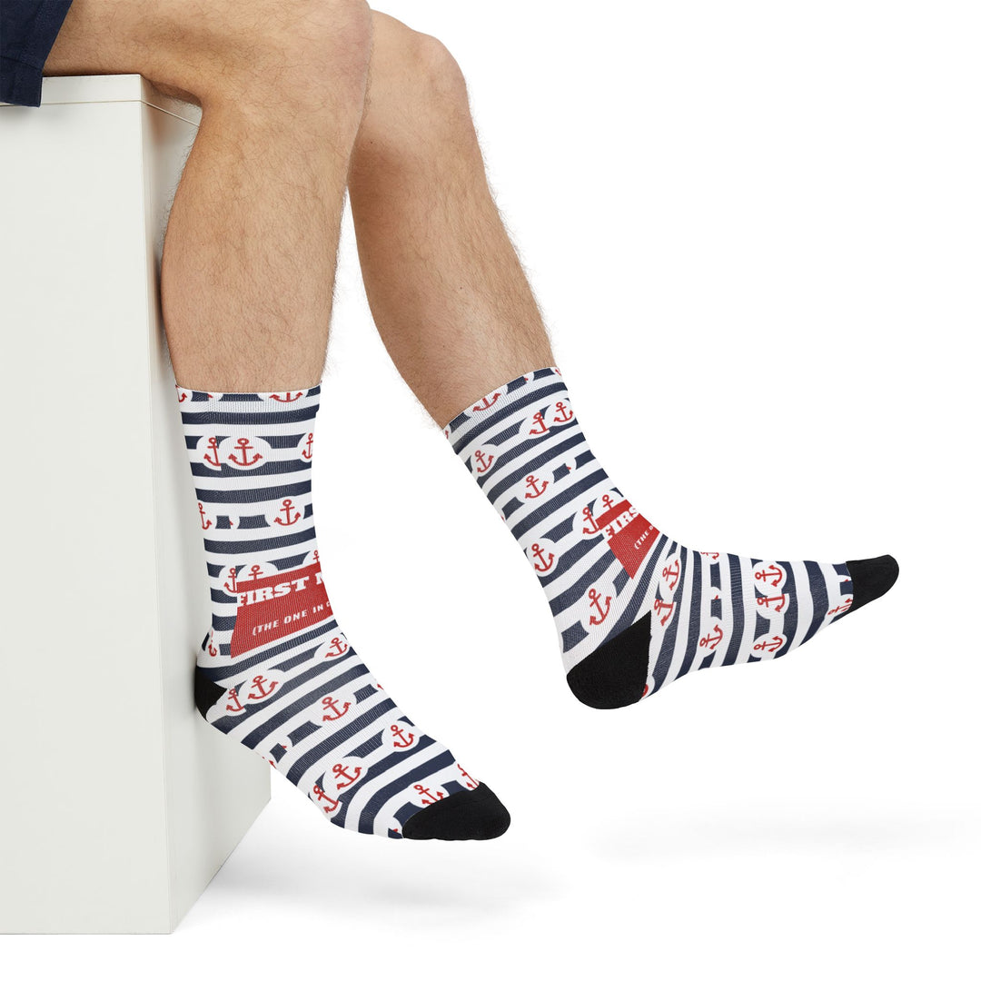 Close side view of crossed feet in navy and white First Mate anchor socks with red anchor rows, Rhode Island socks