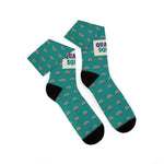 Overlapping folded Quahog Squad clam socks seen from above, black heels and toes with the cream Quahog Squad band