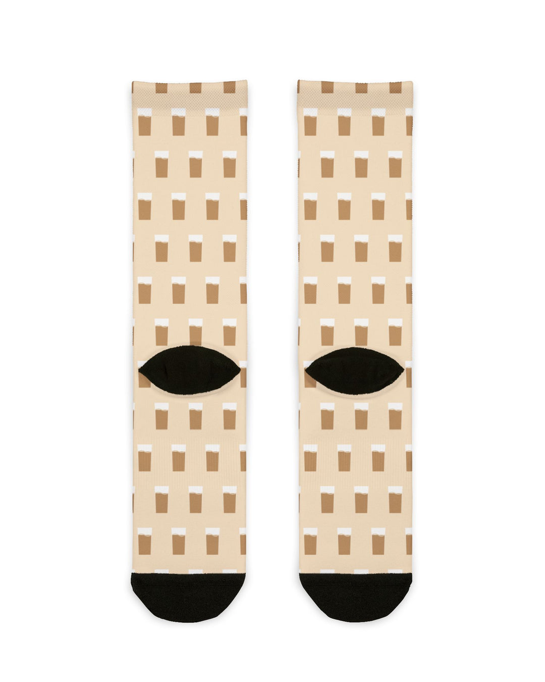 Back of cream Raised on Coffee Milk crew socks showing black heels and allover brown coffee milk print, flat lay