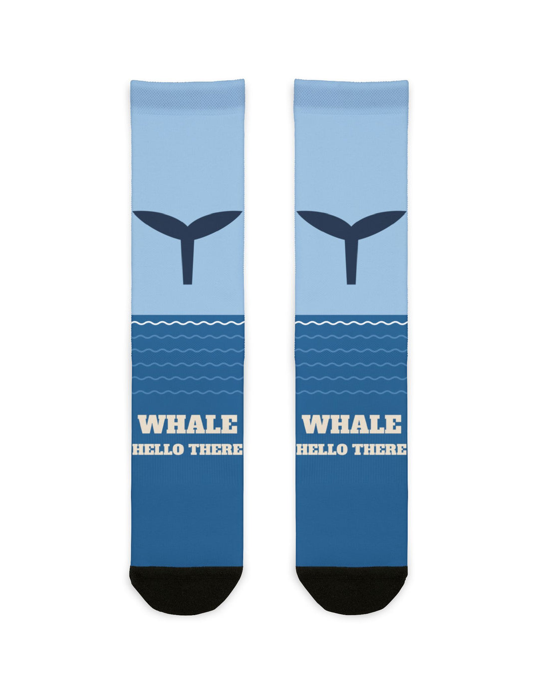 Whale Hello There socks laid flat: light-to-deep blue ocean socks with a navy whale tail and black heel and toe