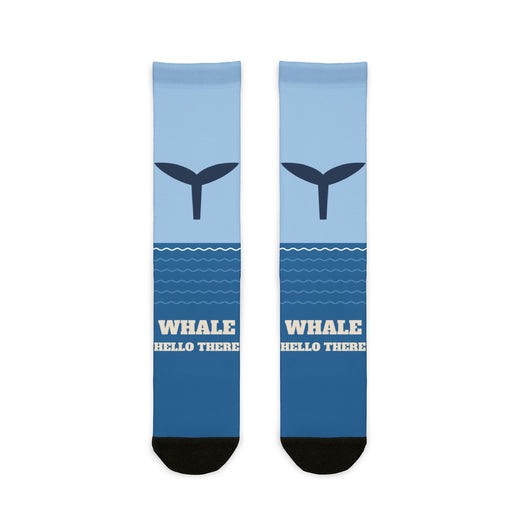 Whale Hello There socks laid flat: light-to-deep blue ocean socks with a navy whale tail and black heel and toe