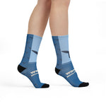 Model walking in Whale Hello There crew socks, front view of the whale tail and slogan on blue gradient socks