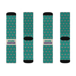 Flat lay of four Quahog Squad Rhode Island socks, fronts and backs, teal clam print with black toes and cream bands