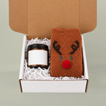 Block Island gift box with amber candle (sample blank label shown) and brown fuzzy reindeer socks