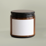 Amber glass candle jar with blank sample label; yours carries the Home for the Holidays Block Island gift label