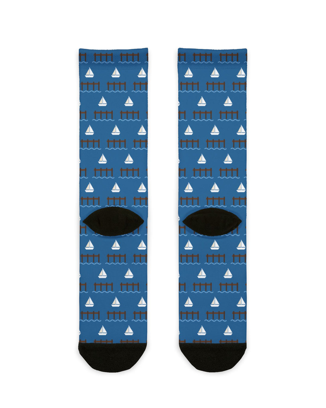 Back flat lay of blue Big Dock Energy nautical crew socks showing sailboat print and black heels and toes