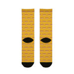 Back of mustard yellow Rhode Island hot wiener socks flat lay with rows of wieners and black heels
