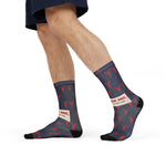 Model in navy shorts mid-stride showing the Pinch Me slogan band on navy and red lobster socks