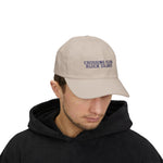 Man in a black hoodie wearing the Stone Crossing Club Block Island hat, front view with head tilted down