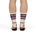 Front view of legs standing in Knot Today nautical crew socks, navy cuff band with red and white lettering