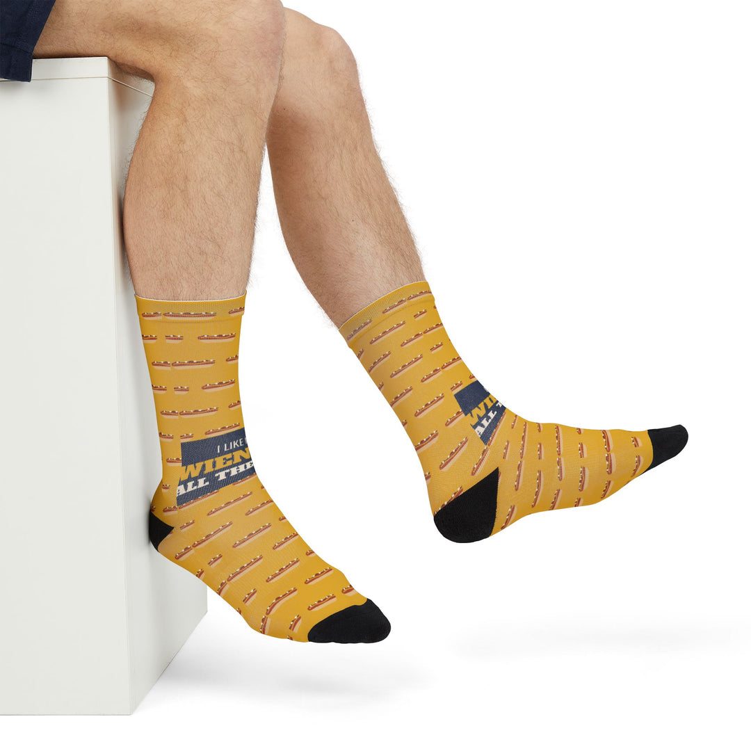 Crossed legs in I Like My Wieners All the Way Rhode Island gift socks with navy band, side view