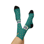 Model's crossed legs raised overhead in teal Quahog Squad Rhode Island socks, black heels and cream band toward camera