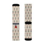 Tan retro sailor socks laid flat showing the navy banner, red heart tattoo and allover black anchor print