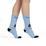 Model standing in light blue Rhode Island socks with navy Block Island map and red Block Island: actually an island