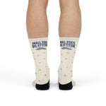 Front view of standing model wearing white Small State. Big Attitude. Rhode Island socks with navy wave print