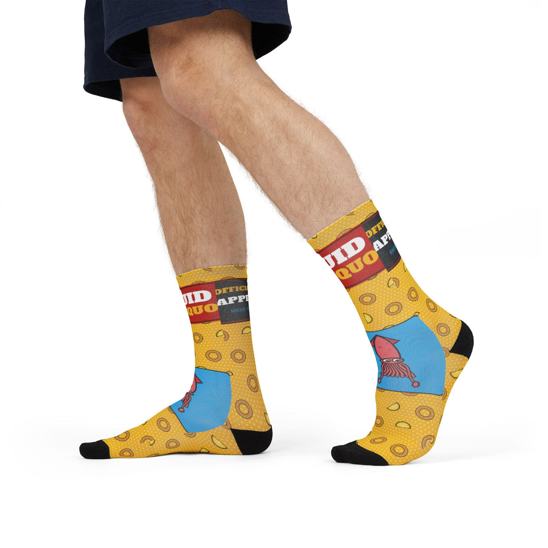 Model in denim shorts mid-stride wearing yellow Squid Pro Quo funny beach socks with calamari ring print