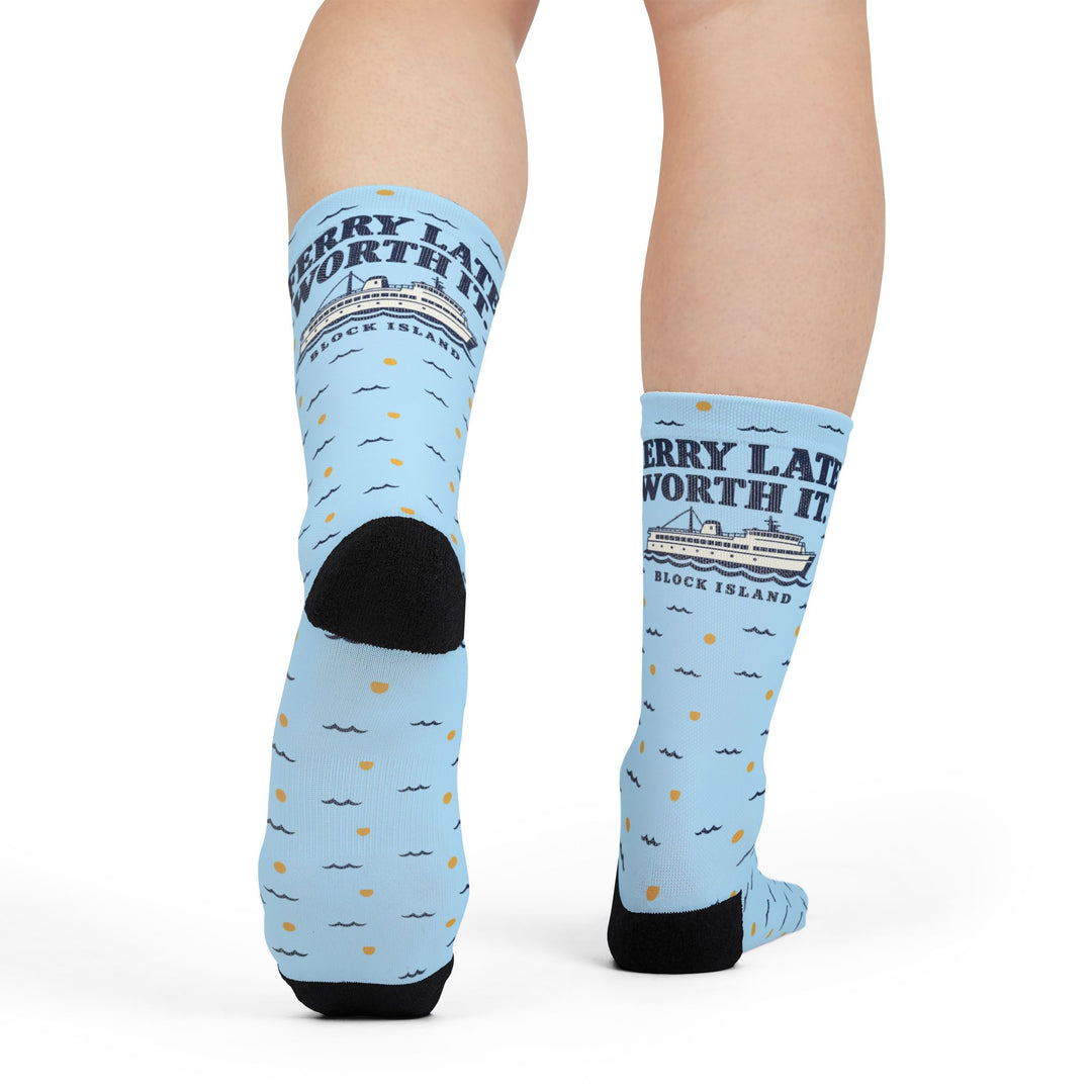Rear view of Ferry Late. Worth It. Block Island crew socks on a model, black heel and printed ferry graphic