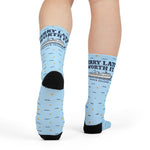 Rear view of Ferry Late. Worth It. Block Island crew socks on a model, black heel and printed ferry graphic