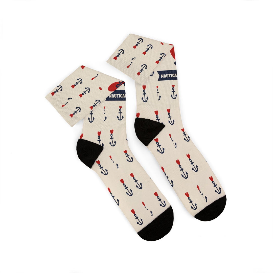 Folded pair of tan nautical crew socks showing black heels and the red heart and anchor tattoo print