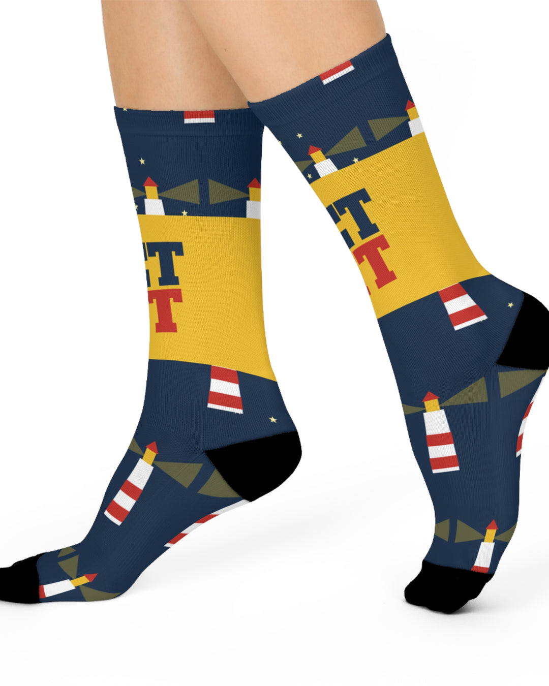 Side view of a walking model in navy Get Lit lighthouse socks with red and white lighthouses and light beams