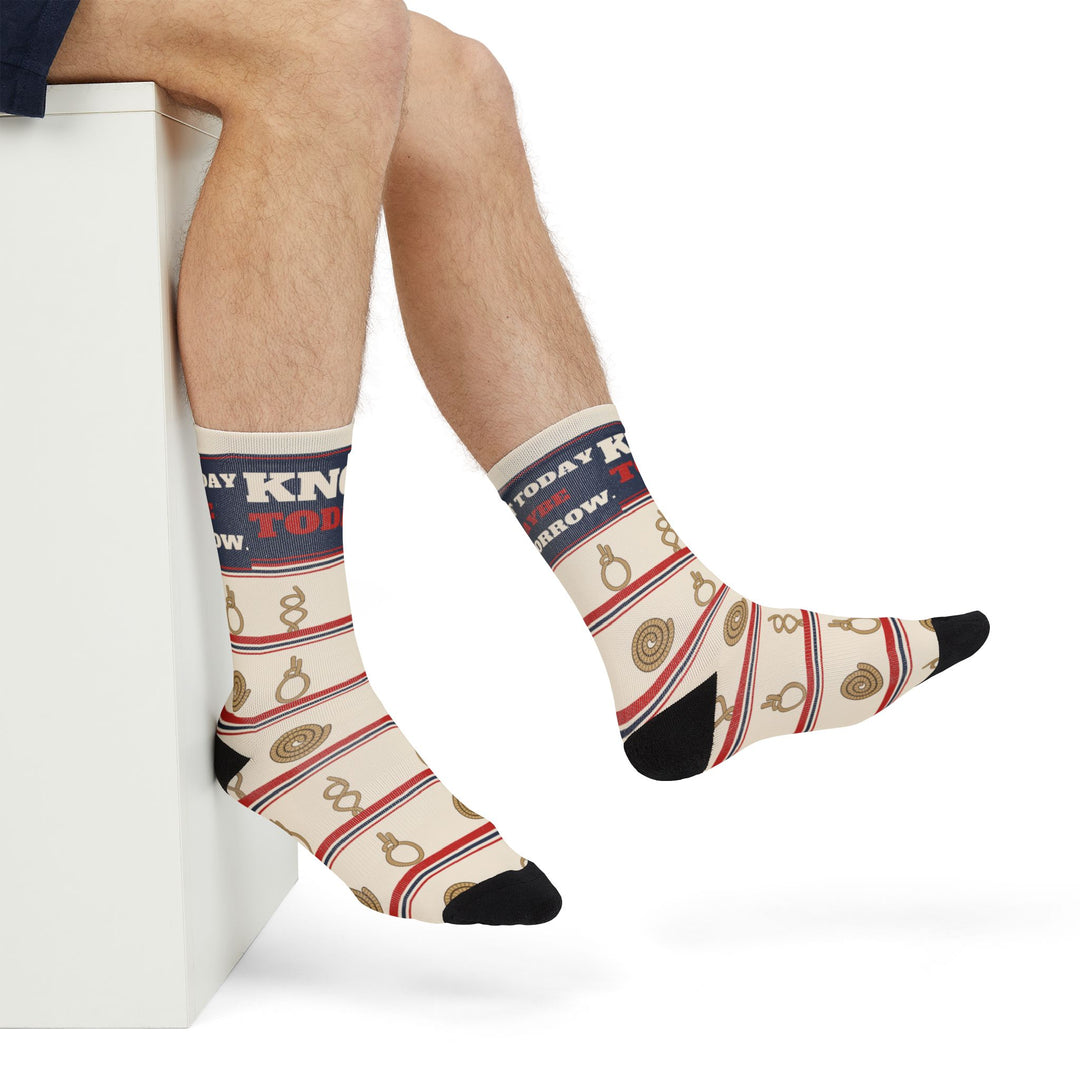 Side view of crossed legs in cream Knot Today nautical crew socks with navy band - a funny sailing gift