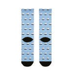Back view of light blue sailboat socks with black heels and a repeating regatta sailboat pattern