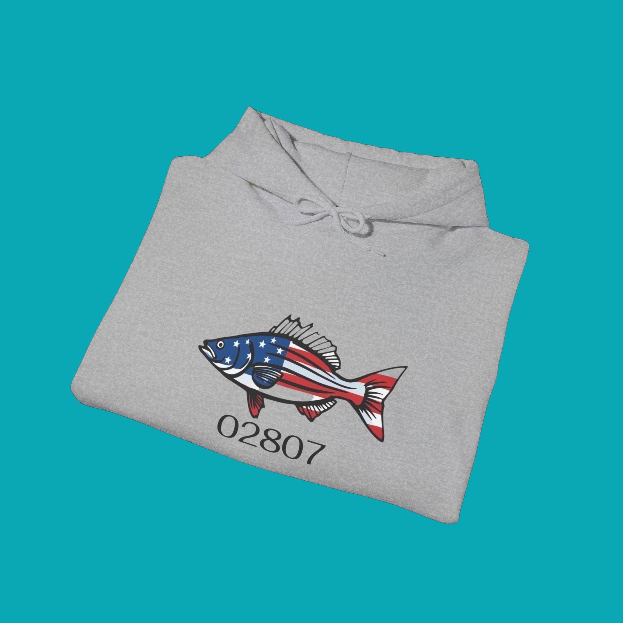 BlockBoundRI heather grey hooded sweatshirt featuring a striped bass graphic with American flag pattern and 02807 text