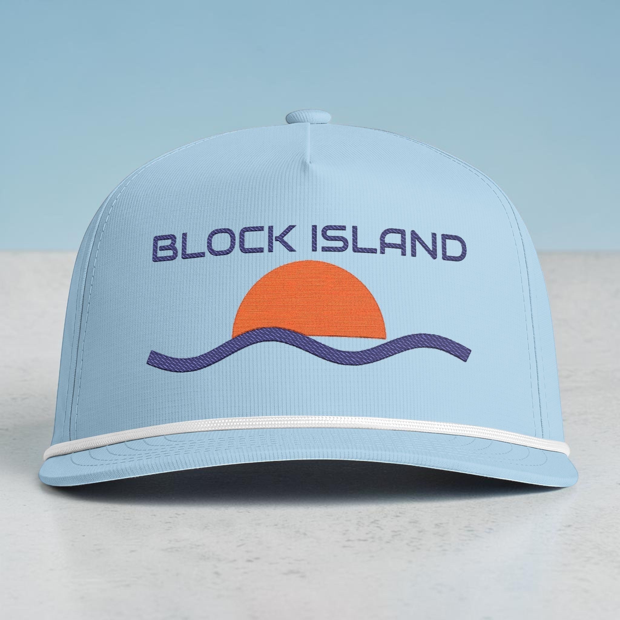 BlockBoundRI light blue five-panel cap with a retro sunset and wave embroidery and white rope trim on the curved bill.