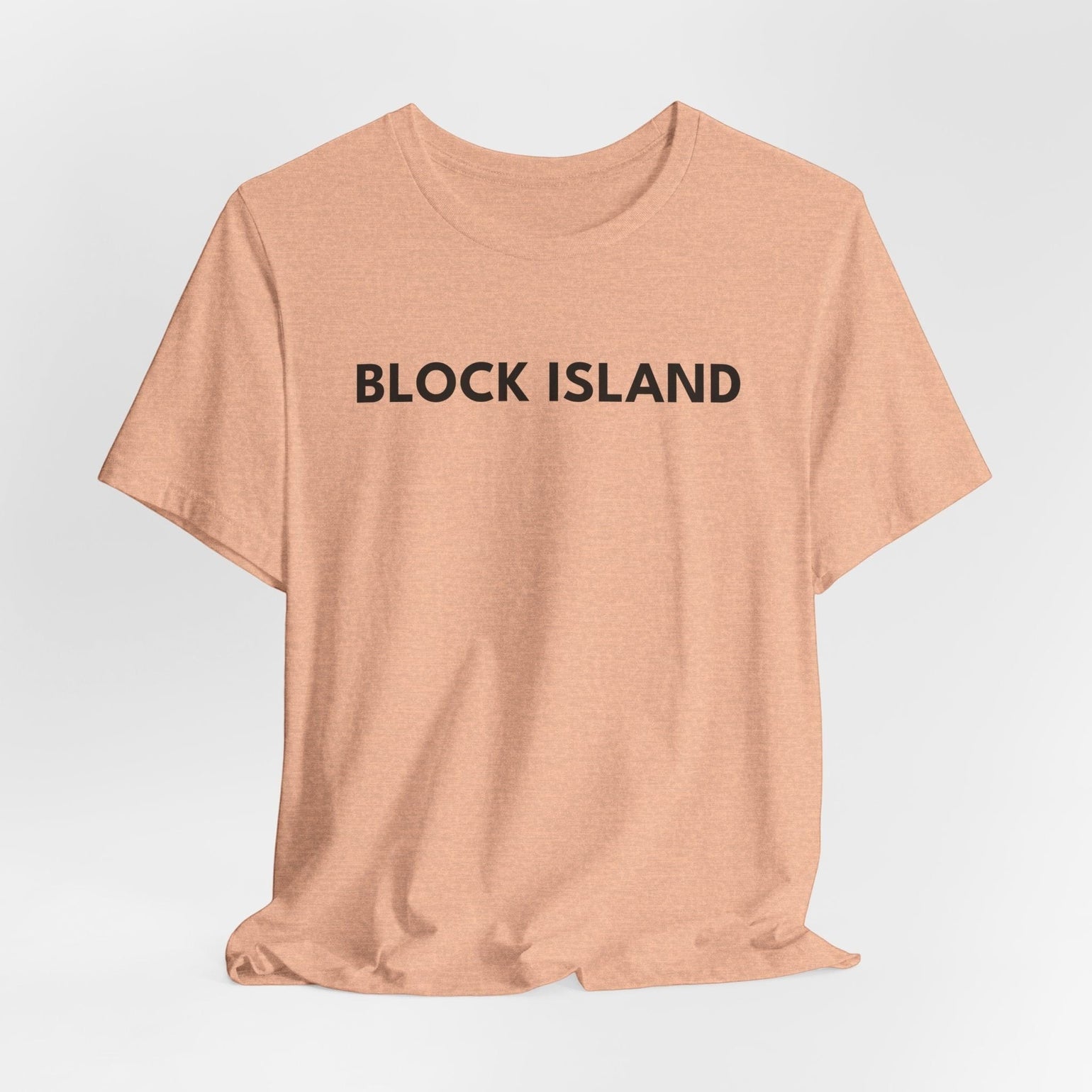 BlockBoundRI peach-colored crew neck t-shirt with BLOCK ISLAND printed in minimalist black text on the chest.